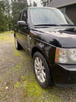 2006 Land Rover Range Rover Sport 4X4 parked, black exterior, showcasing new features and condition.