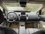 Interior view of a 2005 Toyota Prius showing dashboard, steering wheel, and seating.