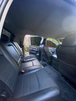 Interior view of a 2018 Ram 2500 Mega Cab with spacious black leather seats and clean design.