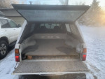 Open rear view of a Toyota Tacoma Xtracab with a clean truck bed, ready for road trips.