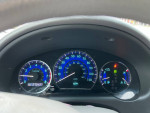 Dashboard of a 2009 Toyota Sienna LE showing speedometer and gauges, ideal for family travel.