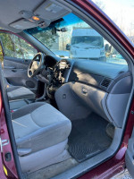 Interior view of a 2009 Toyota Sienna LE, showing well-maintained seating and controls.