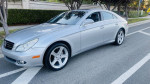 2007 Mercedes-Benz CLS550 in silver, showcasing sleek design and polished wheels, parked on the street.
