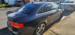 2011 Audi S4 Prestige, a sleek black car parked, showcasing its sporty design and tinted windows.