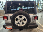 Rear view of a 2019 Jeep Wrangler Sport 4WD, showing spare tire and clean design, low mileage vehicle.