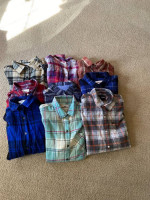 Several trash bags of brand name clothes